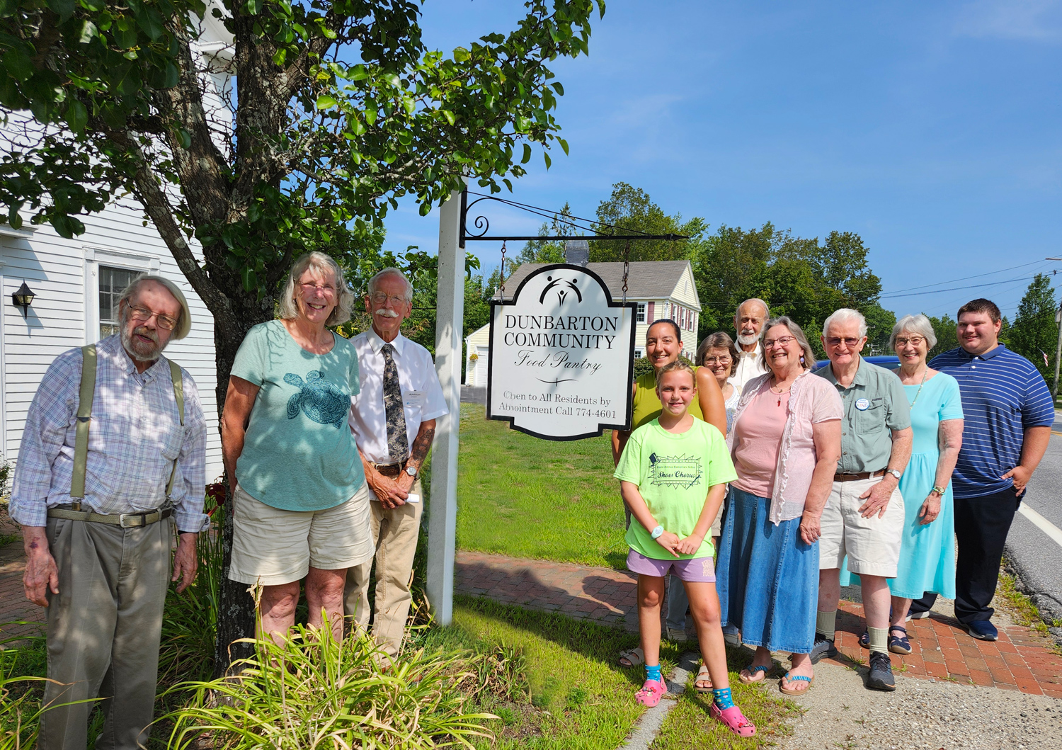 Church members in front of the Food Pantry sign